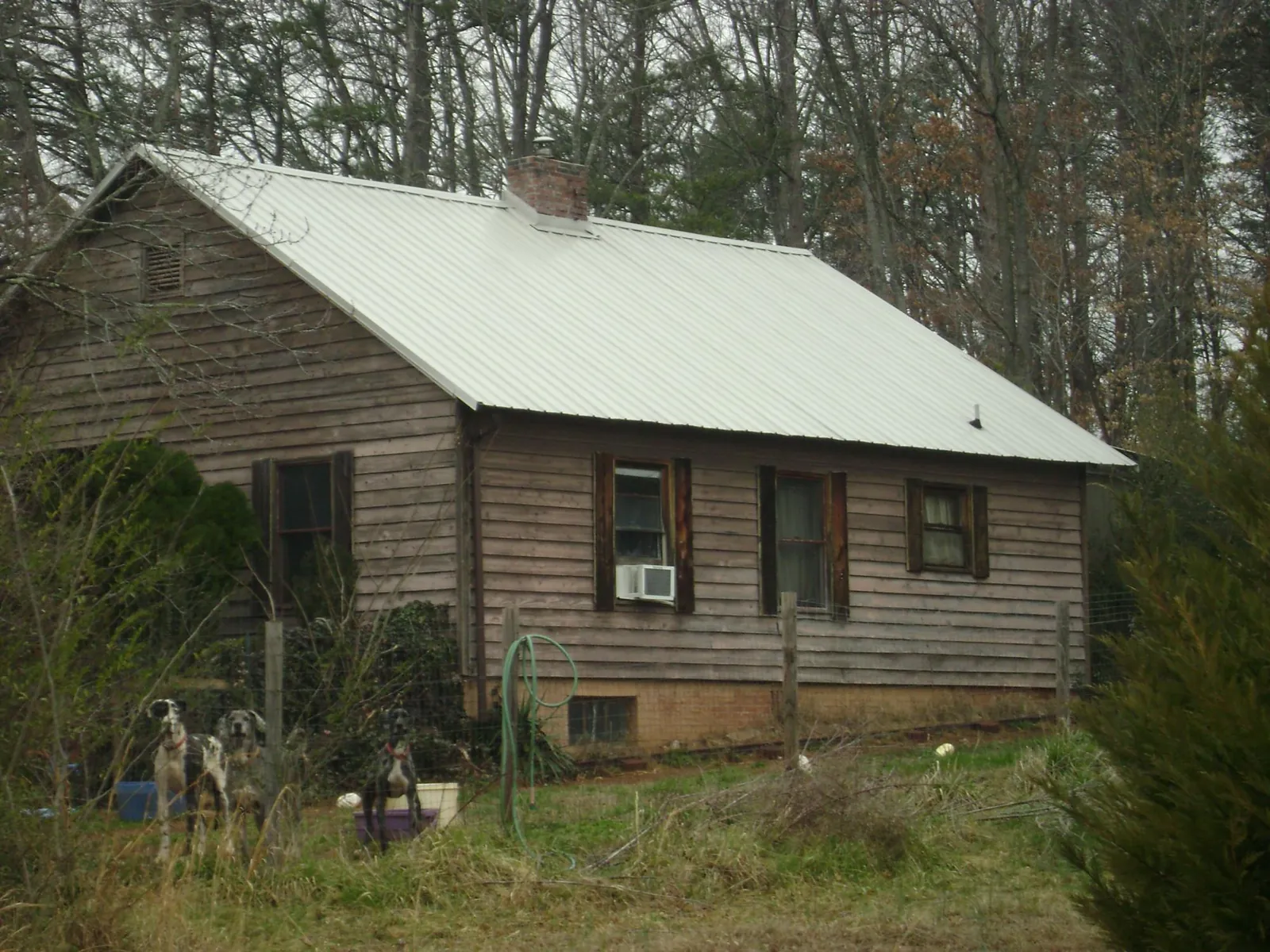 White metal roof on an old wood sided farmhouse, from a Metal Roof Installation job in Brodhead